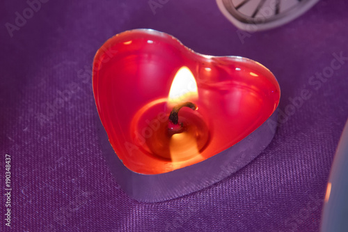 Candles red hearts with small hearts . Pink background . Red heart shaped rcandles burning Valentines day concept