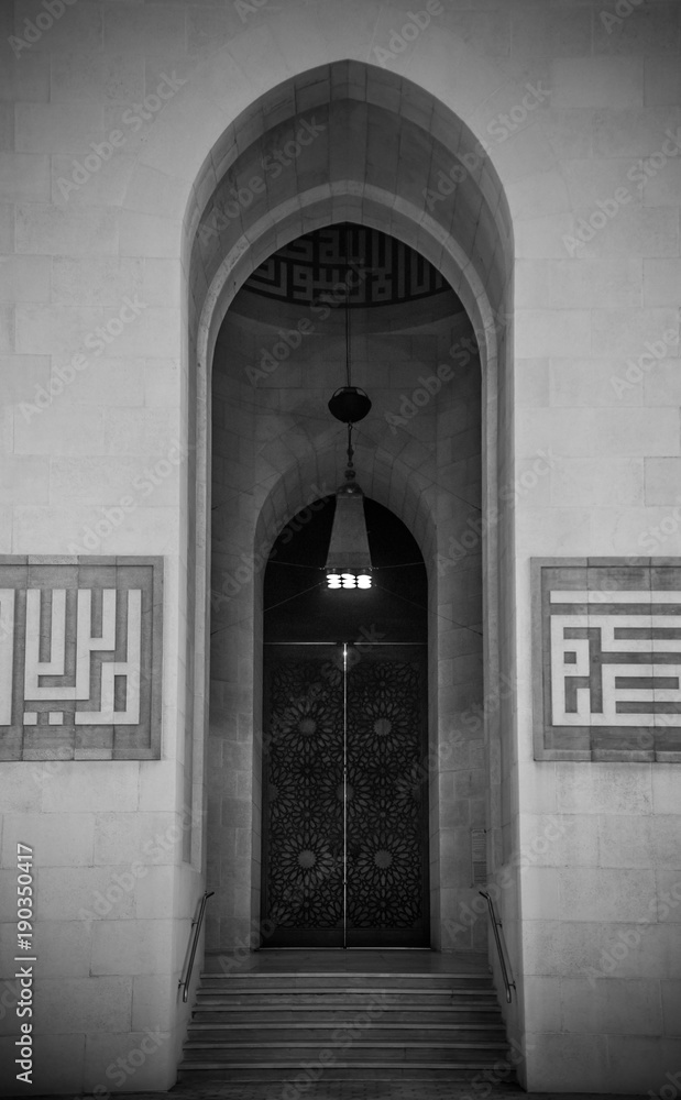 Arch gate exterior of Al Fateh grand mosque in evening.  Manama, Bahrain