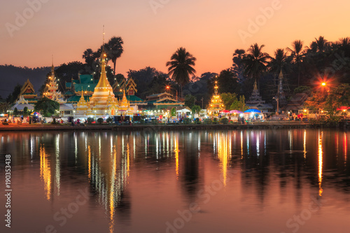 Reflection with lake.Beautiful temple across lake for photographic early morning and before sun set.Wat Chong Kham Buddhist temple in Mae Hong Son,Thailand.