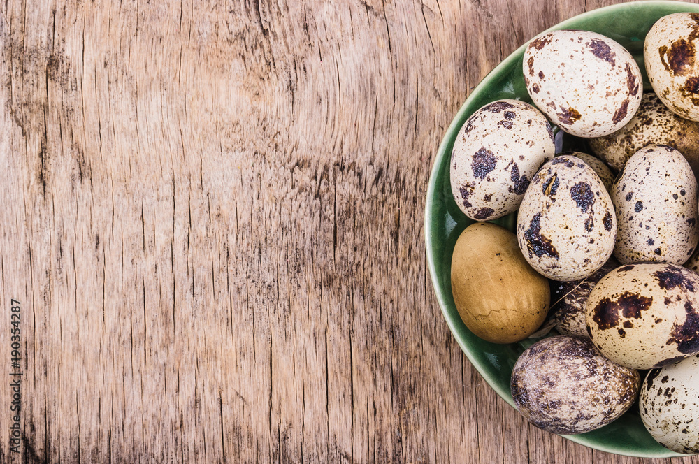 Fresh quail eggs on a wooden board. Vegetarian diet. Copy space. Top View Fresh quail eggs on a wooden board. Vegetarian diet. Copy space. Top View