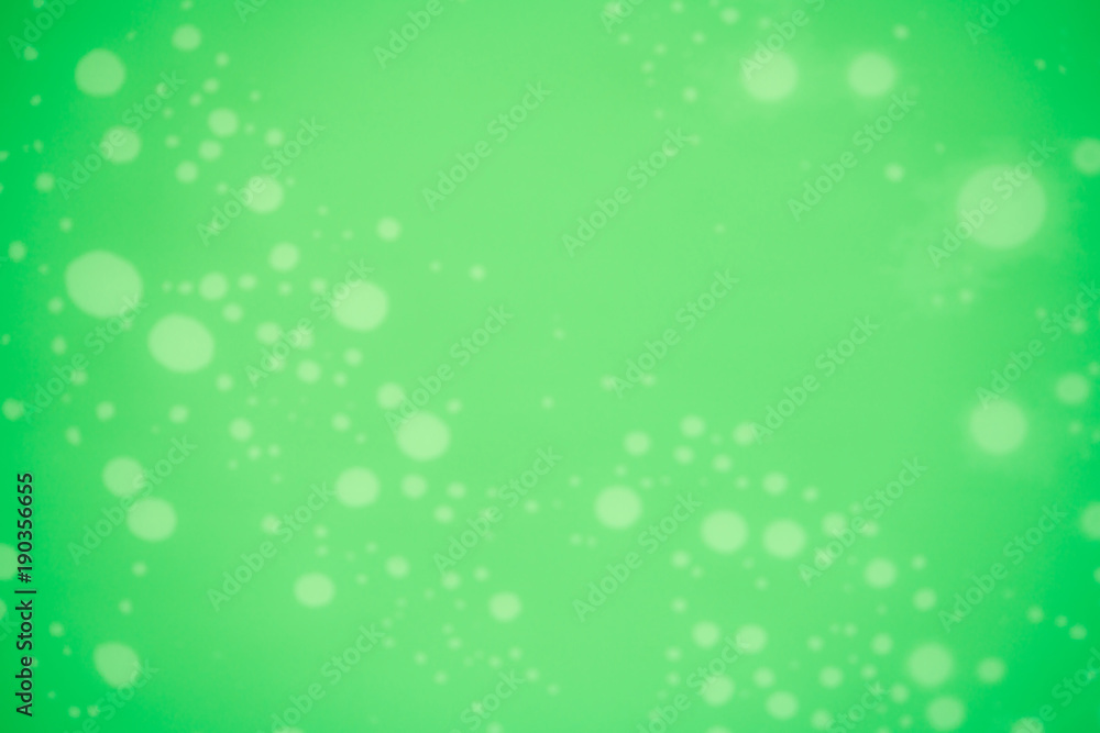 Blurred green texture background with white dotted pattern. Christmas background with copy space for text Blurred green texture background with white dotted pattern. Christmas background with copy space for text
