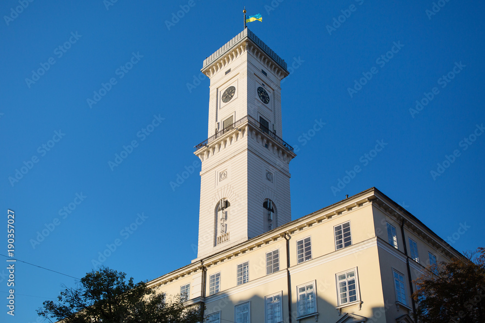 Closeup of the town hall of Lviv over the blue sky. Central tower with clock in Lviv, Ukraine