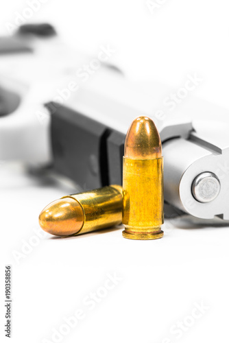  Bullets and guns are placed on white ground.