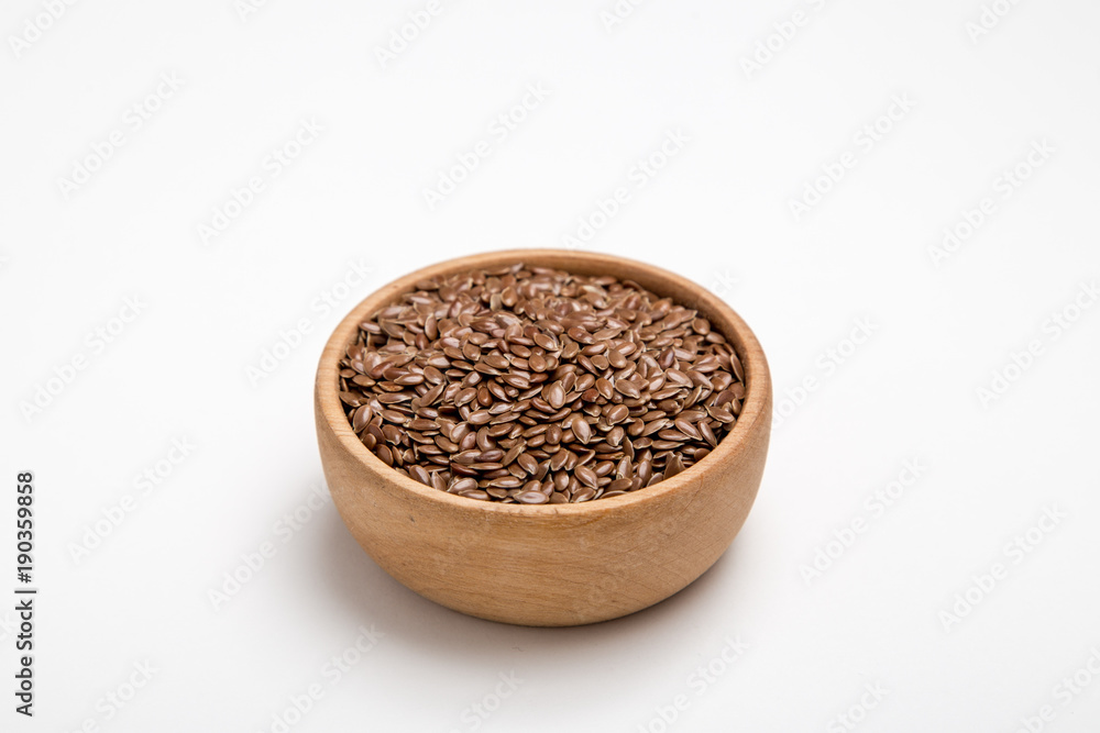 close up of flax seeds on white background. Healthy food concept for preventing heart diseases and overweight. close up of flax seeds on white background. Healthy food concept for preventing heart diseases and overweight.