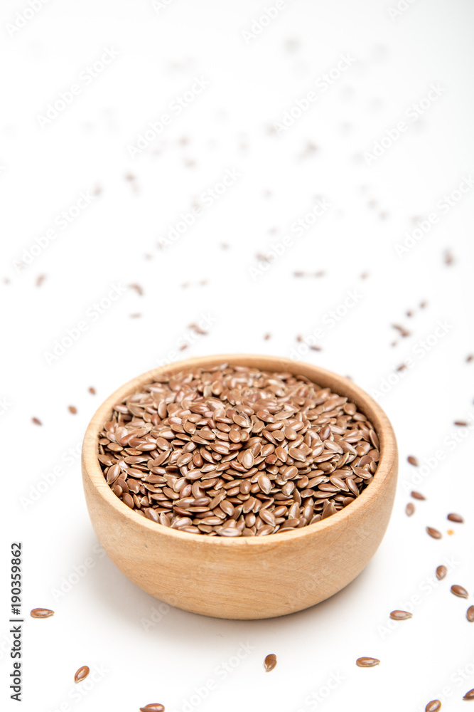 close up of flax seeds on white background. Healthy food concept for preventing heart diseases and overweight. close up of flax seeds on white background. Healthy food concept for preventing heart diseases and overweight.