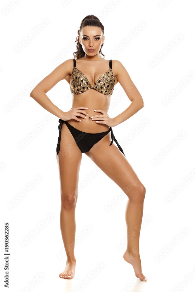 Beautiful fashion model in black bikini on white background Beautiful fashion model in black bikini on white background