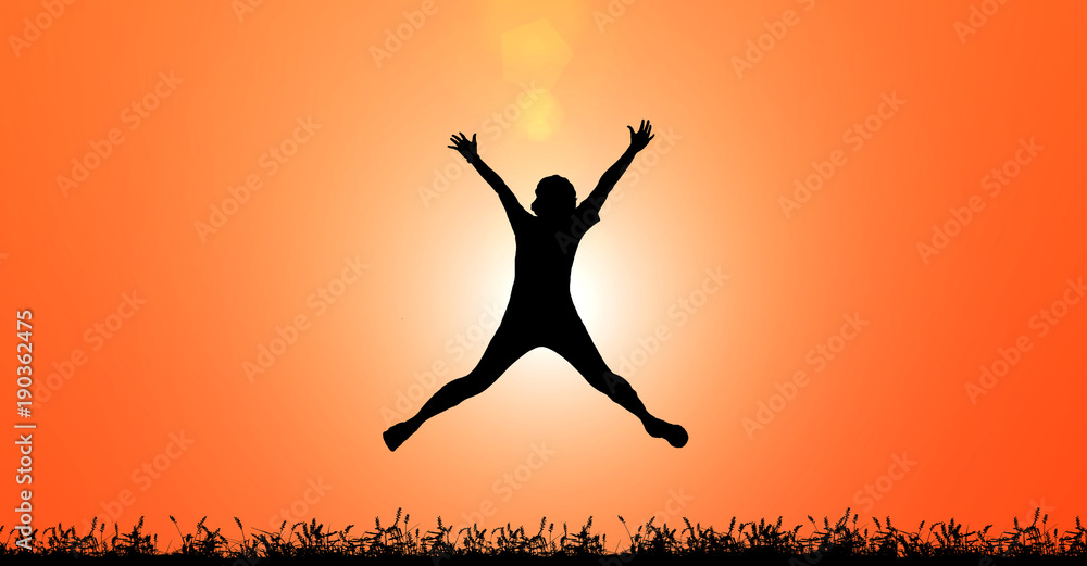 Silhouette woman jumping for joy and happiness on sunset