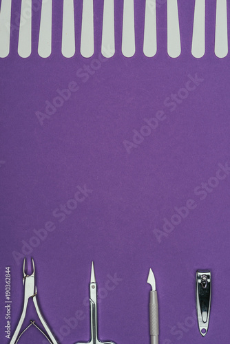 top view of manicure tools isolated on purple