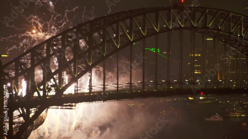 A full shot of a bridge and fireworks on a new year
