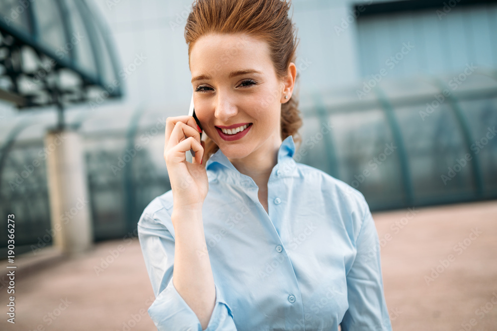Portrait of businesswoman walking and talking on phone Portrait of businesswoman walking and talking on phone