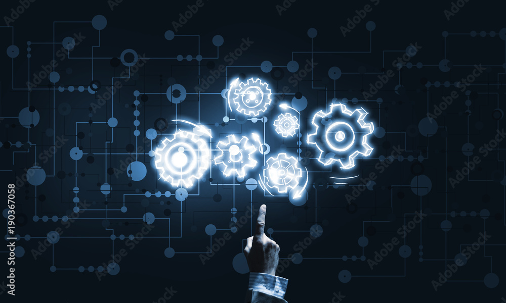 Glowing cogwheel mechanism icon on dark background as symbol of teamwork Glowing cogwheel mechanism icon on dark background as symbol of teamwork