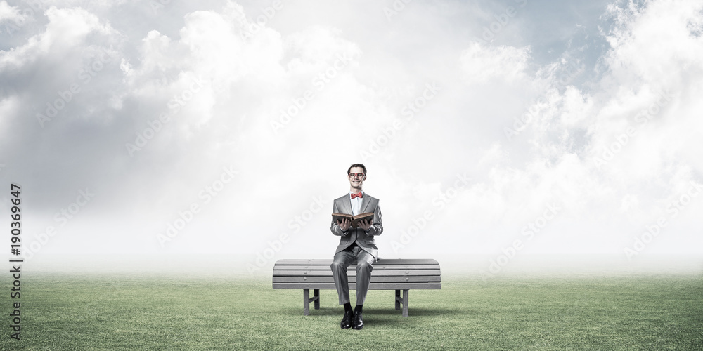 Young businessman or student studying the science in summer park Young businessman or student studying the science in summer park