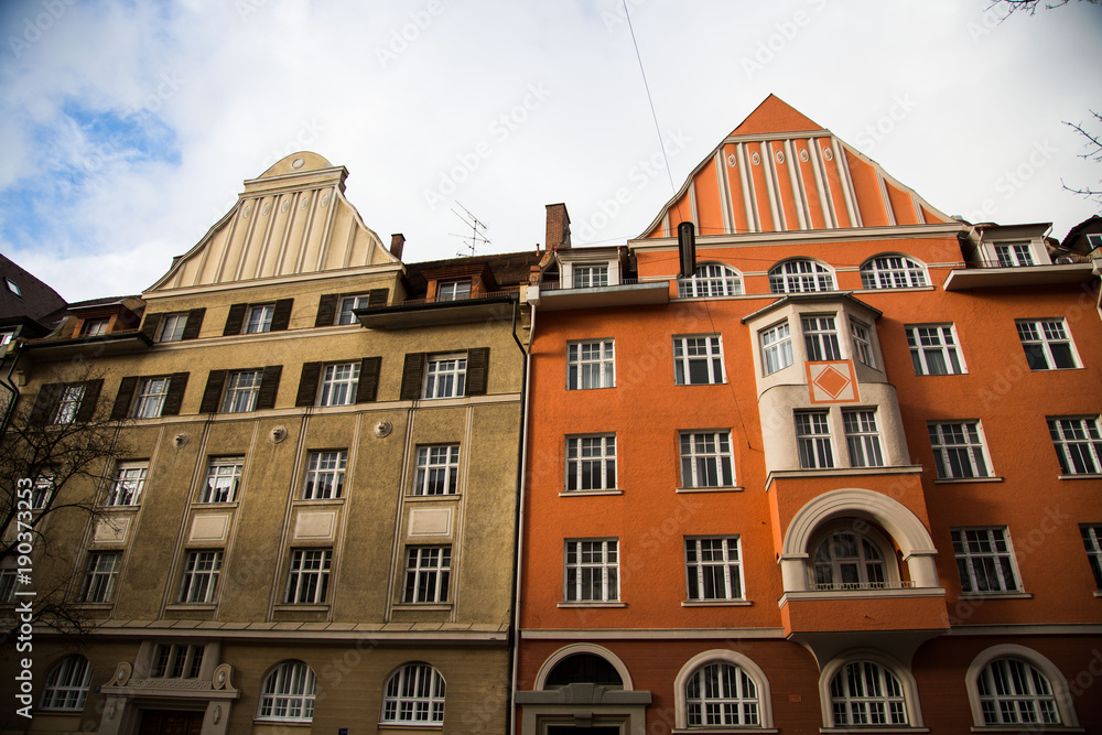 Fototapeta premium Old houses in Schwabing, orange and green facade
