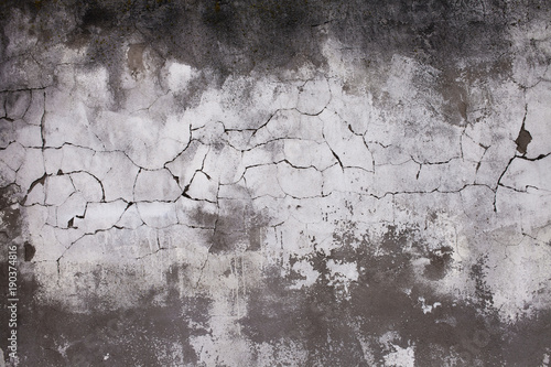 Old concrete wall with cracks. Aged cracked plaster wall background and textu...