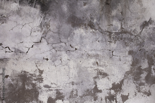 Old concrete wall with cracks. Aged cracked plaster wall background and textu...