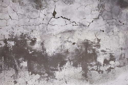 Old concrete wall with cracks. Aged cracked plaster wall background and textu...