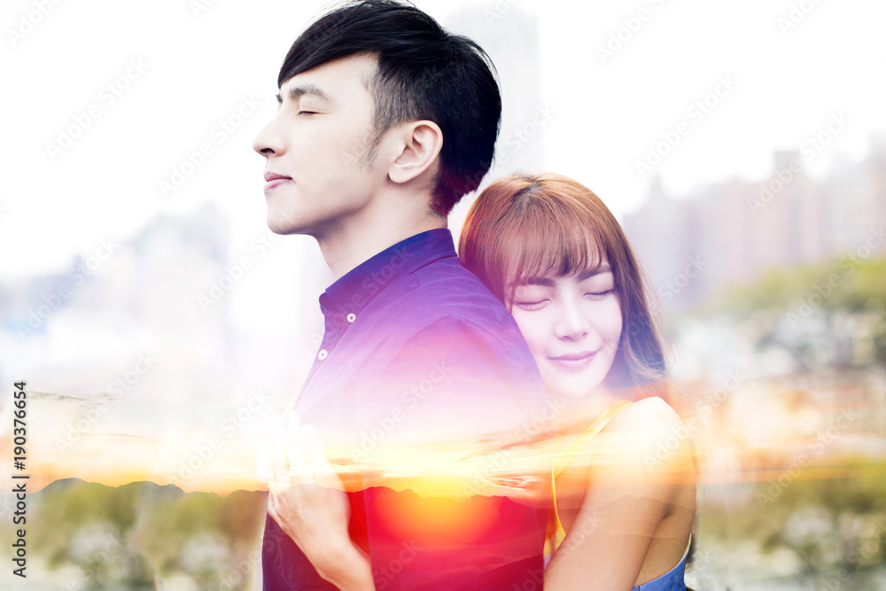 romantic young couple hugging and sunset background. romantic young couple hugging and sunset background.