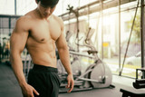 strong fitness man posing muscular body and doing exercises for bodybuilder in the gym, fitness concept, sport concept