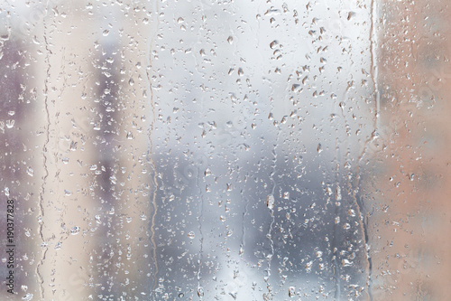 rain drops on window glass in winter day