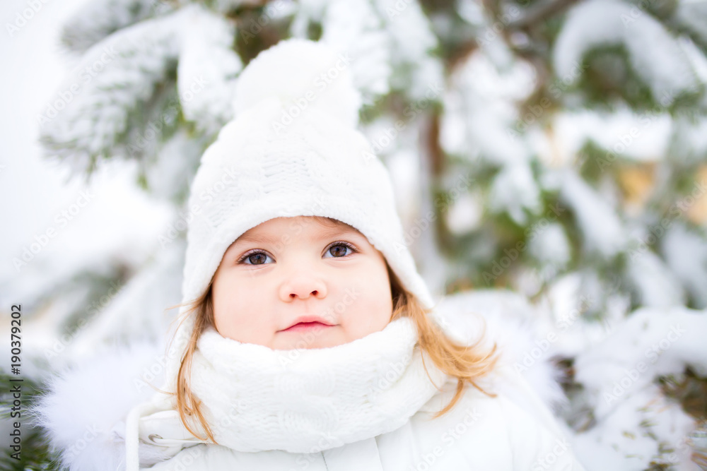Little cute toddler girl portrait, outdoors on a sunny winter day. Little cute toddler girl portrait, outdoors on a sunny winter day.