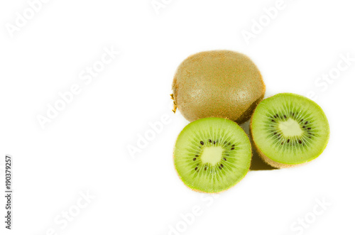 Fresh green kiwi fruit slice close up partially isolated on white background with selective focus