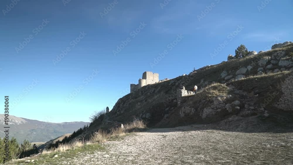 Old fortress illuminated on top of a far hill. Old fortress illuminated on top of a far hill.