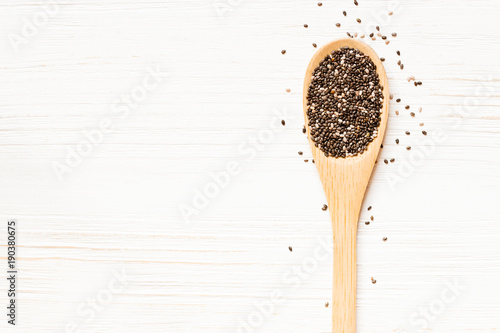 Wooden spoon with Chia seeds on white wooden table. Concept of a healthy diet. Super food.