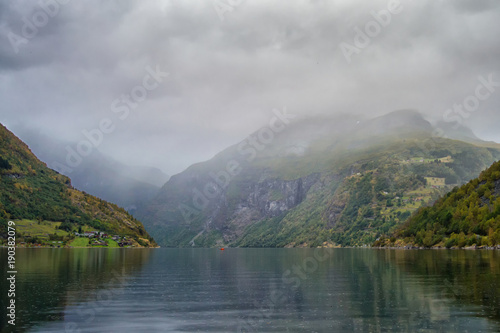 Norwegian fjords. View of the Geyranger fjord in the rain with mountains in the background.