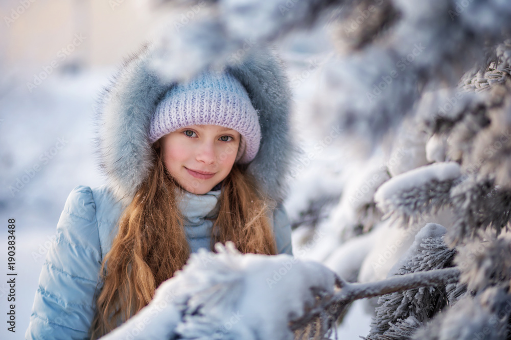 Beautiful young girl in a winter forest Beautiful young girl in a winter forest