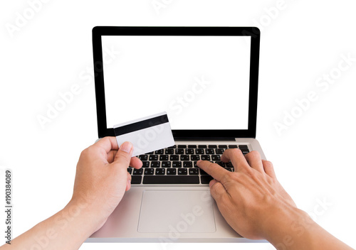 Man hand holding credit card and using laptop blank desktop screen isolated on white background with clipping path