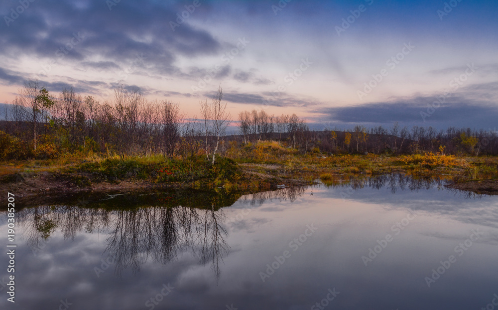 Beautiful autumn sunset on the lake. Reflection of trees in clean calm wat Beautiful autumn sunset on the lake. Reflection of trees in clean calm wat