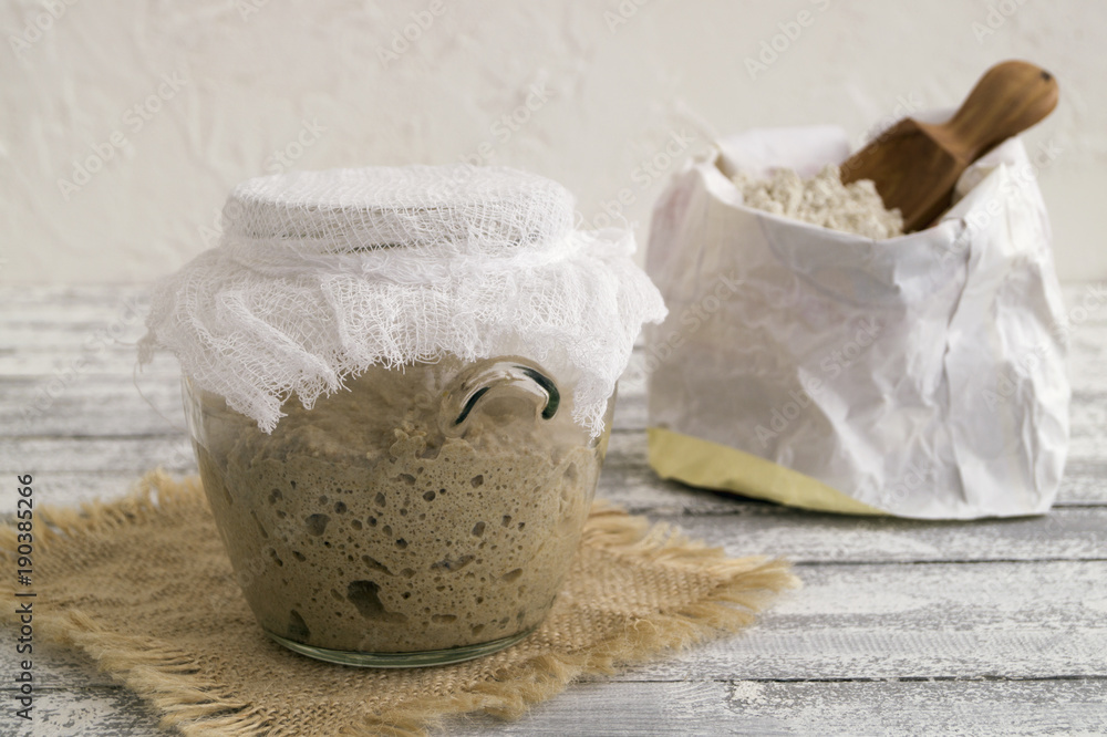 Active rye sourdough in a glass jar for homemade bread. Active rye sourdough in a glass jar for homemade bread.