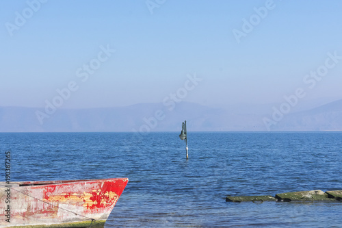 Boat and a street lamp in Lake Vegoritida photo