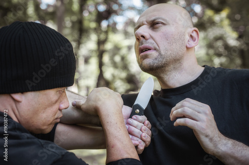 Fotografija Lameco Astig Combatives instructor demonstrates knife attack disarming technique