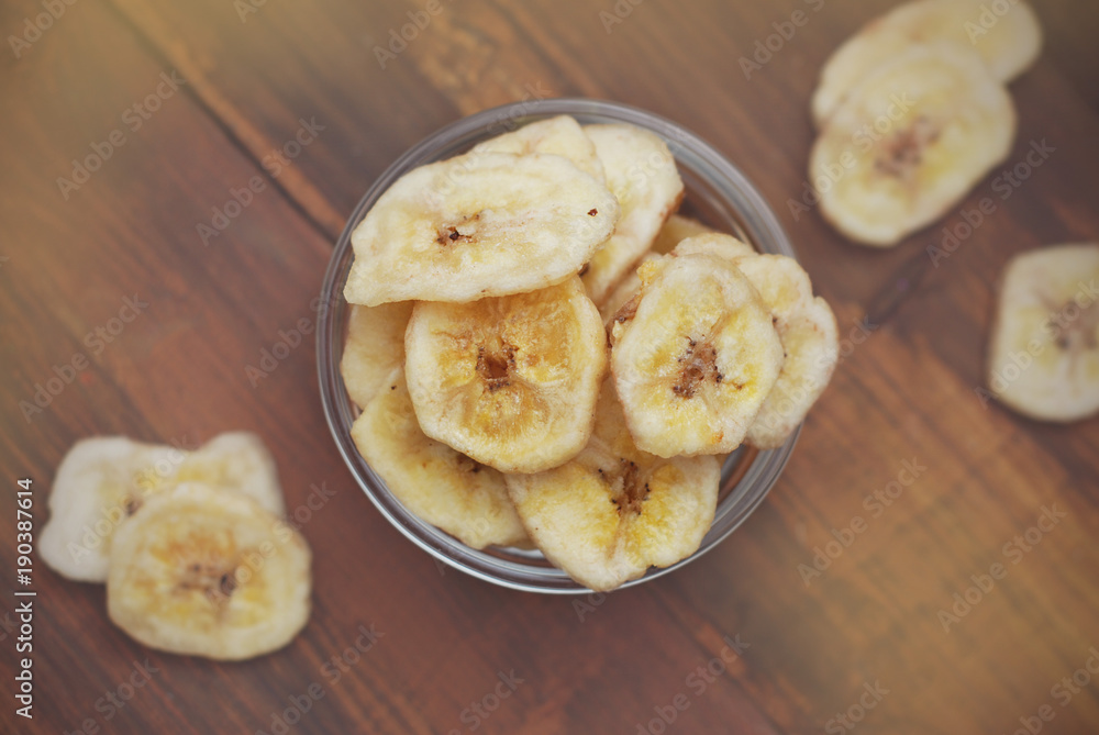 Crunchy Banana Chips on Wooden Background. Healthy Snack Fruit. Banana slices. Diet and Beauty. Crunchy Banana Chips on Wooden Background. Healthy Snack Fruit. Banana slices. Diet and Beauty.