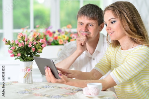 young couple looking at digital tablet
