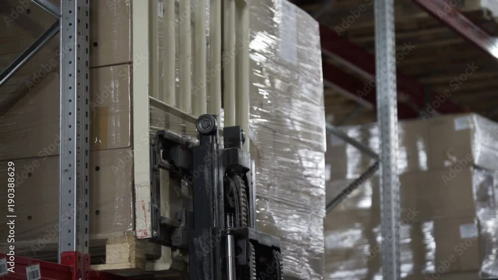 Forklift Trucks load Pallets with Cardboard Boxes at modern warehouse Forklift Trucks load Pallets with Cardboard Boxes at modern warehouse