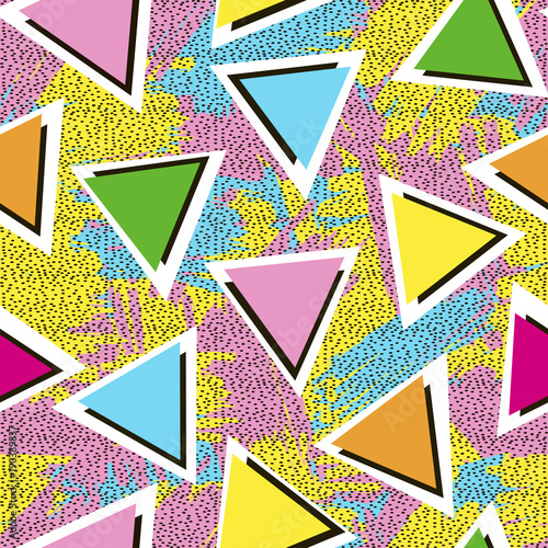 Colorful seamless pattern from triangles on the bright brush strokes background and black dots. 80's - 90's years design style.