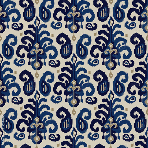 Seamless ikat paisley pattern. Traditional oriental ethnic ornament. Indigo, cobalt blue and beige on ecru background. Textile design.