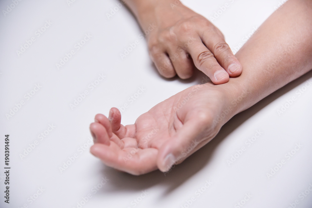 Asian Senior Female checking her pulse. Asian Senior Female checking her pulse.