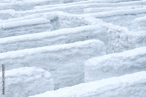 Winter maze with snow walls.