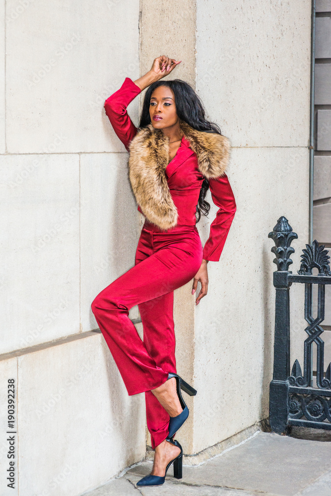 Fashion Woman in New York. Young African American Woman with long hair  dressing in red slim