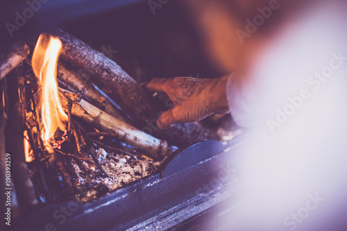 Man kindle a fire in the fireplace