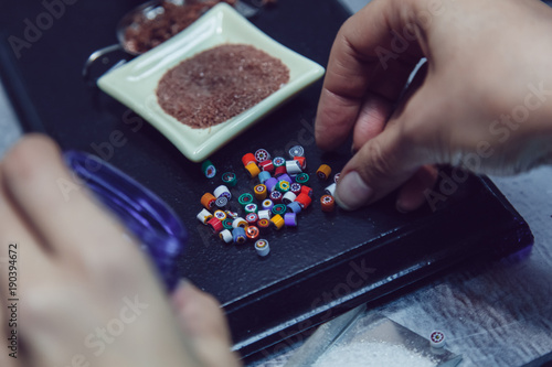 Process of manufacturing costume jewelery from Venetian glass.