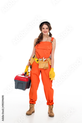 beautiful workwoman in uniform holding toolbox, isolated on white