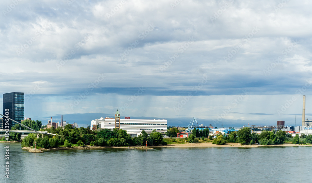 Cityscape and river with dramatic sky