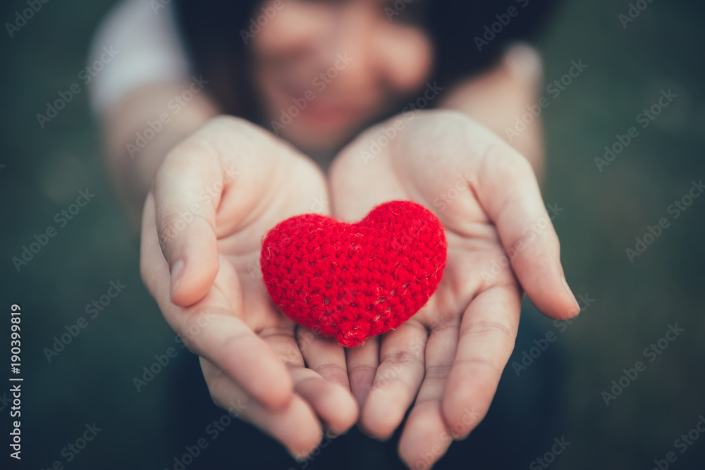 Sharing Love and Heart red color on women hand in valentine's day vintage color tone Sharing Love and Heart red color on women hand in valentine's day vintage color tone