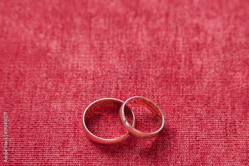 two wedding rings on the background of red velvet