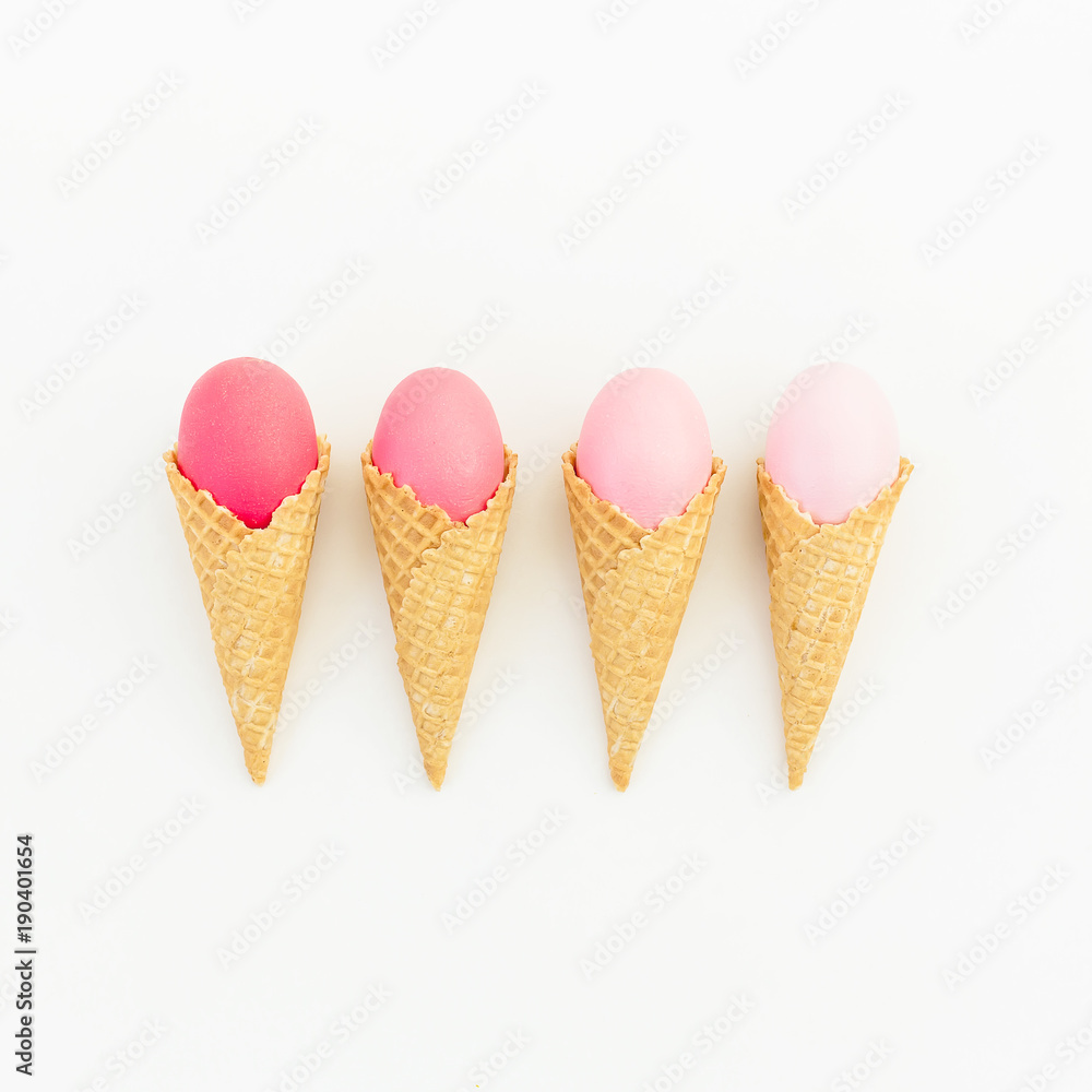 Pink Easter eggs in waffle cone on white background. Flat lay. Top view. Creative holiday concept. Pink Easter eggs in waffle cone on white background. Flat lay. Top view. Creative holiday concept.