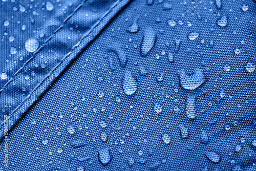 Dark blue rainproof tent sheet with morning rain drops